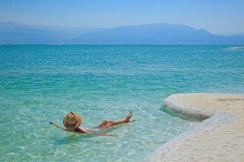Tourist Floating In The Dead Sea Jordan