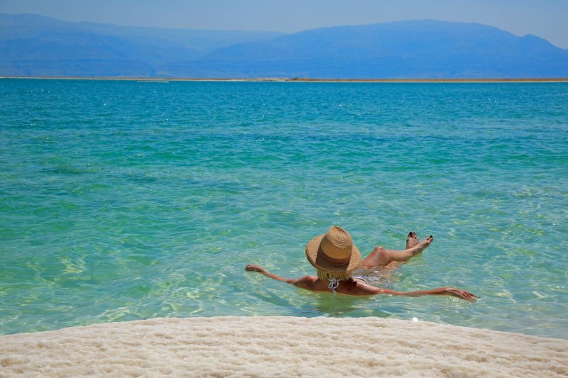 Tourist Floats In The Dead Sea, Israel