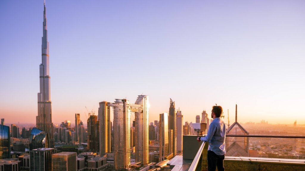 Man Overlooking Dubai Skyline At Sunset