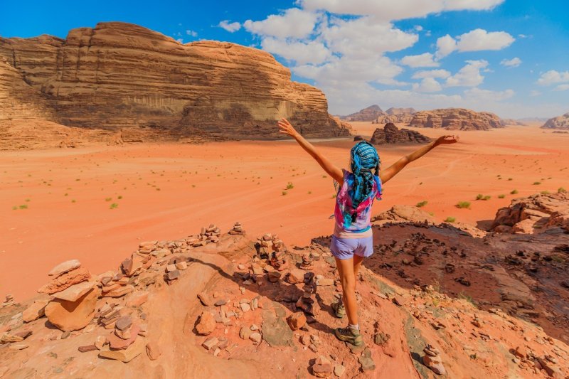 Tourist With Arms Up In Wadi Rum Desert Valley Jordan